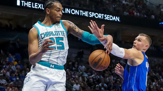 Dec 13, 2021; Dallas, Texas, USA; Dallas Mavericks center Kristaps Porzingis (6) and Charlotte Hornets forward P.J. Washington (25) go for a loose ball during the second quarter at American Airlines Center. Mandatory Credit: Kevin Jairaj-USA TODAY Sports